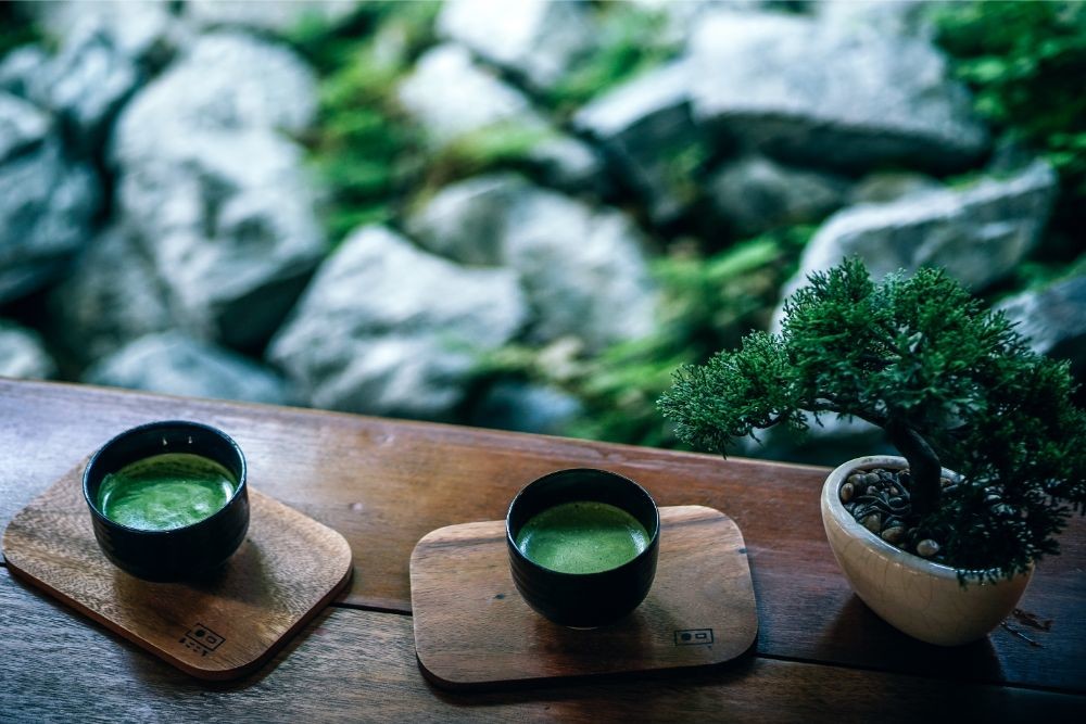 Two Cups of Matcha Tea Served on Wooden Boards at the Magokoro Japanese teahouse