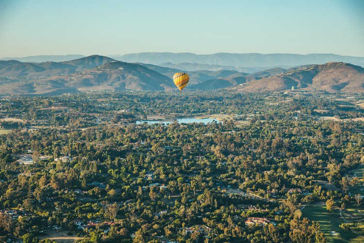 yellow and red hot air balloon floating somewhere North Africa