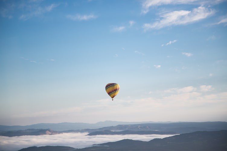 solo hot air balloon floating high in the sky