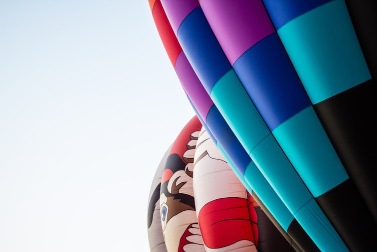 side view of multiple hot air balloons