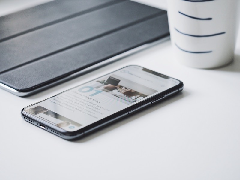 smartphone laying on a white table desk