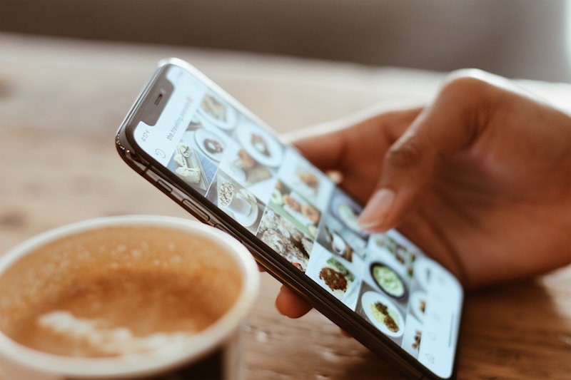 Woman looking at food photos on instagram