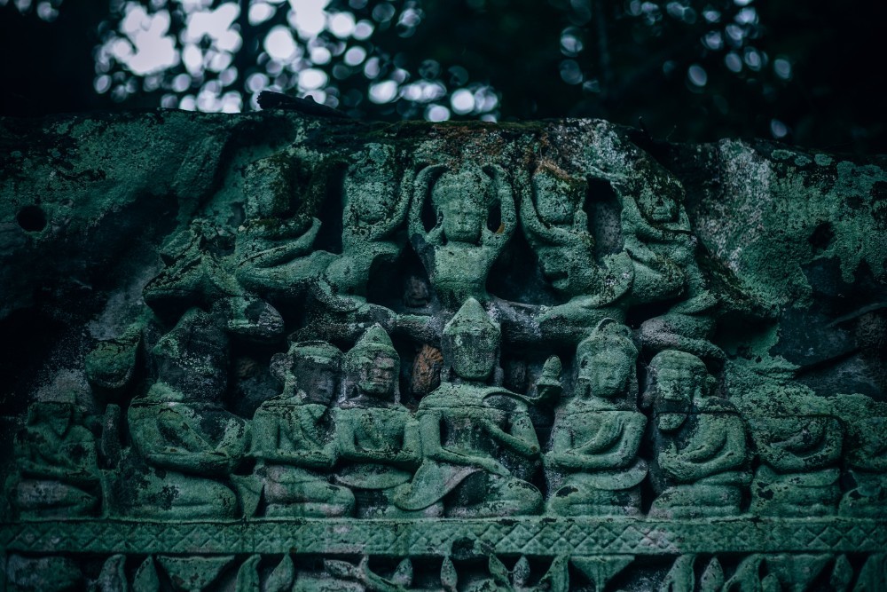 Beautiful Statues at a Temple in Cambodia Covered in Moss