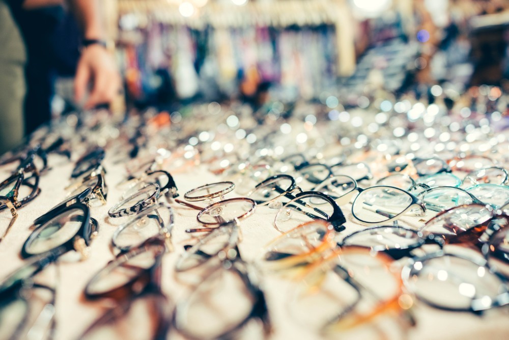 Many Different Eyeglasses Presented on a White Sheet for Sale