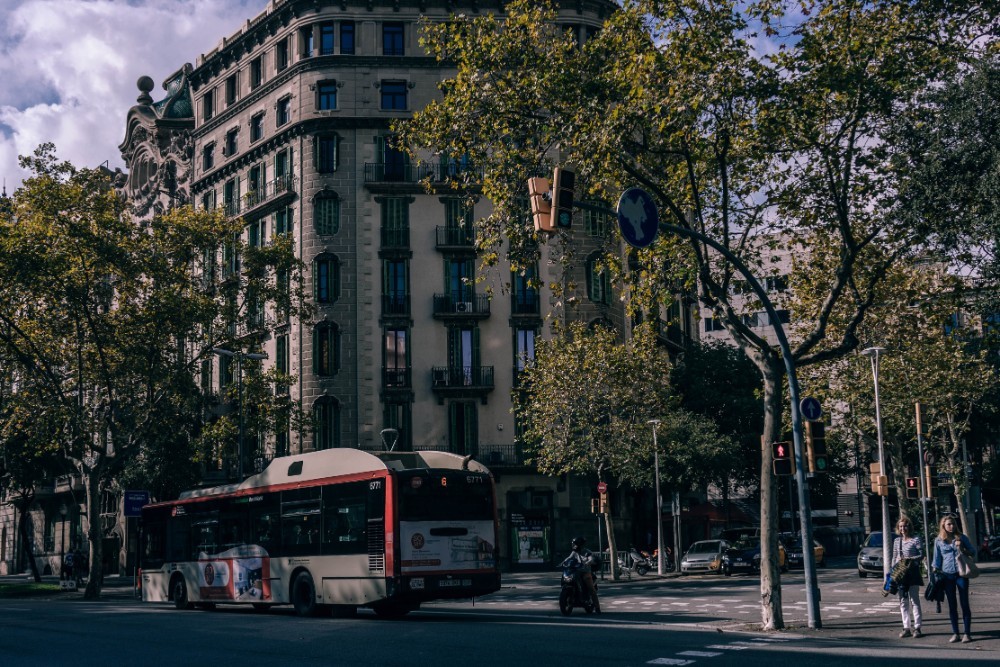 Public Bus and a Motorbike on the Streets of Barcelona