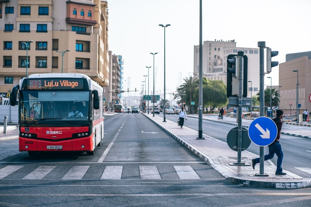 Red Public Transport Bus Waiting for the Green Light