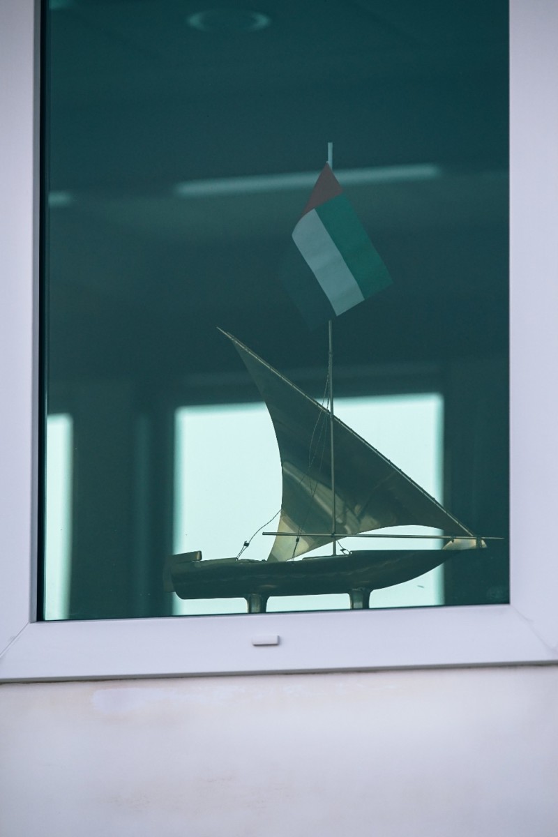 Small Display Boat in a Window with the UAE Flag on it