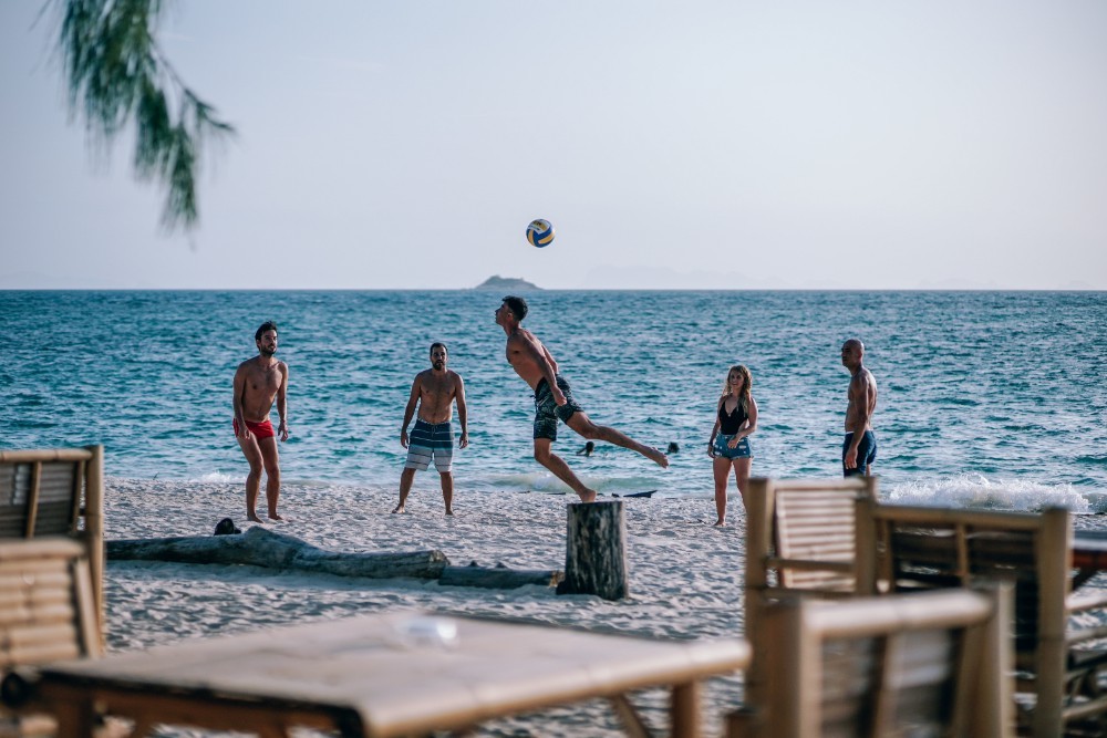 Friends Playing with a Volleyball at The Beach