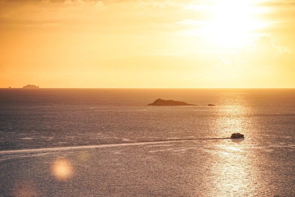 Golden Sunset in Thailand with a Speed Boat passing by