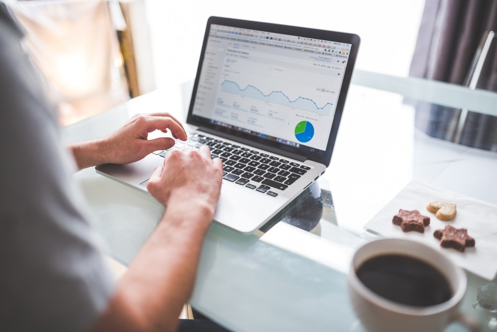 Man using his laptop to check google analytics