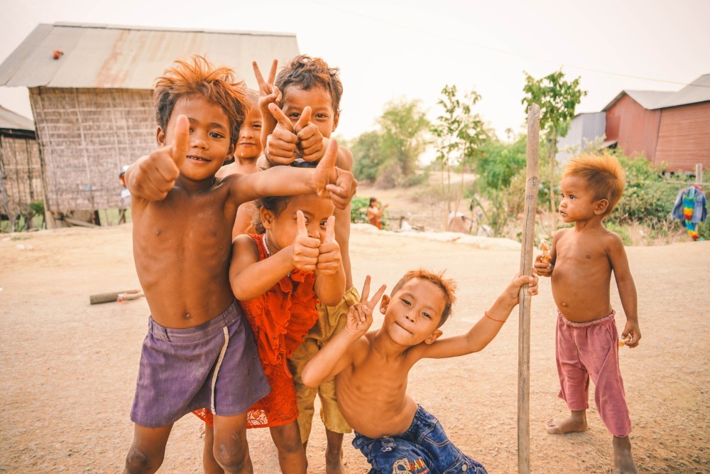 Small Cambodian Kids Smiling and Showing Thumbs Up to the Camera