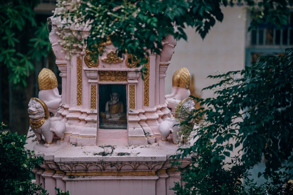 Small Pink Temple with Golden Decorations and a Buddha Statue Inside