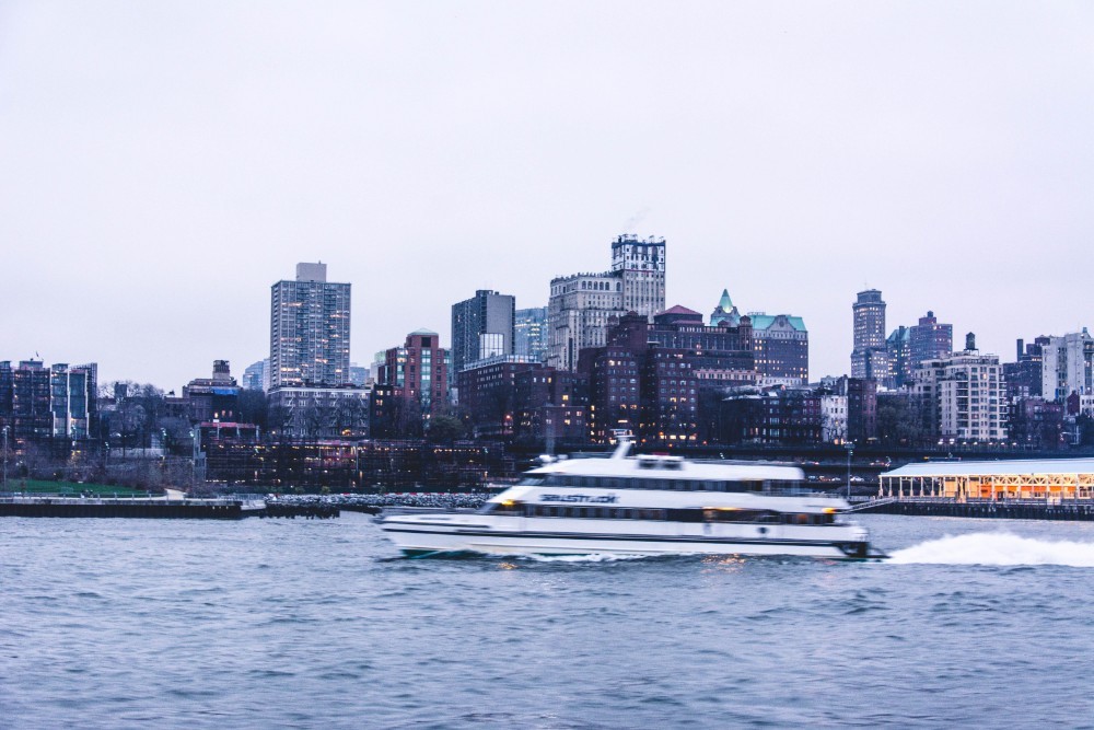 Speedboat Driving on the East River with Beautiful Buildings in the Background