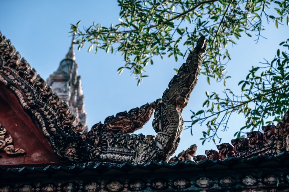 Traditional Asian Roof with the Sky and Tree Leaves in the Background