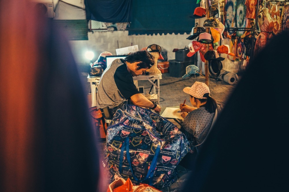 A Man and a Woman Drawing at the Night Market in Chiang Mai