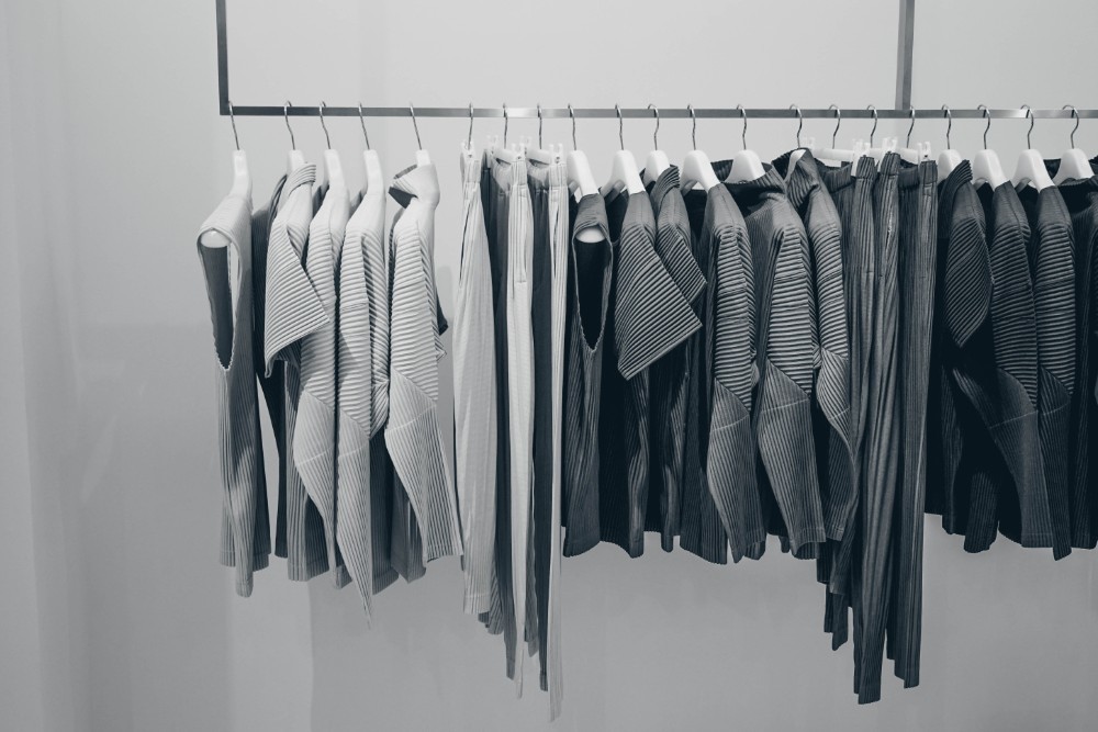 Black and White Photography of a Clothing Rack