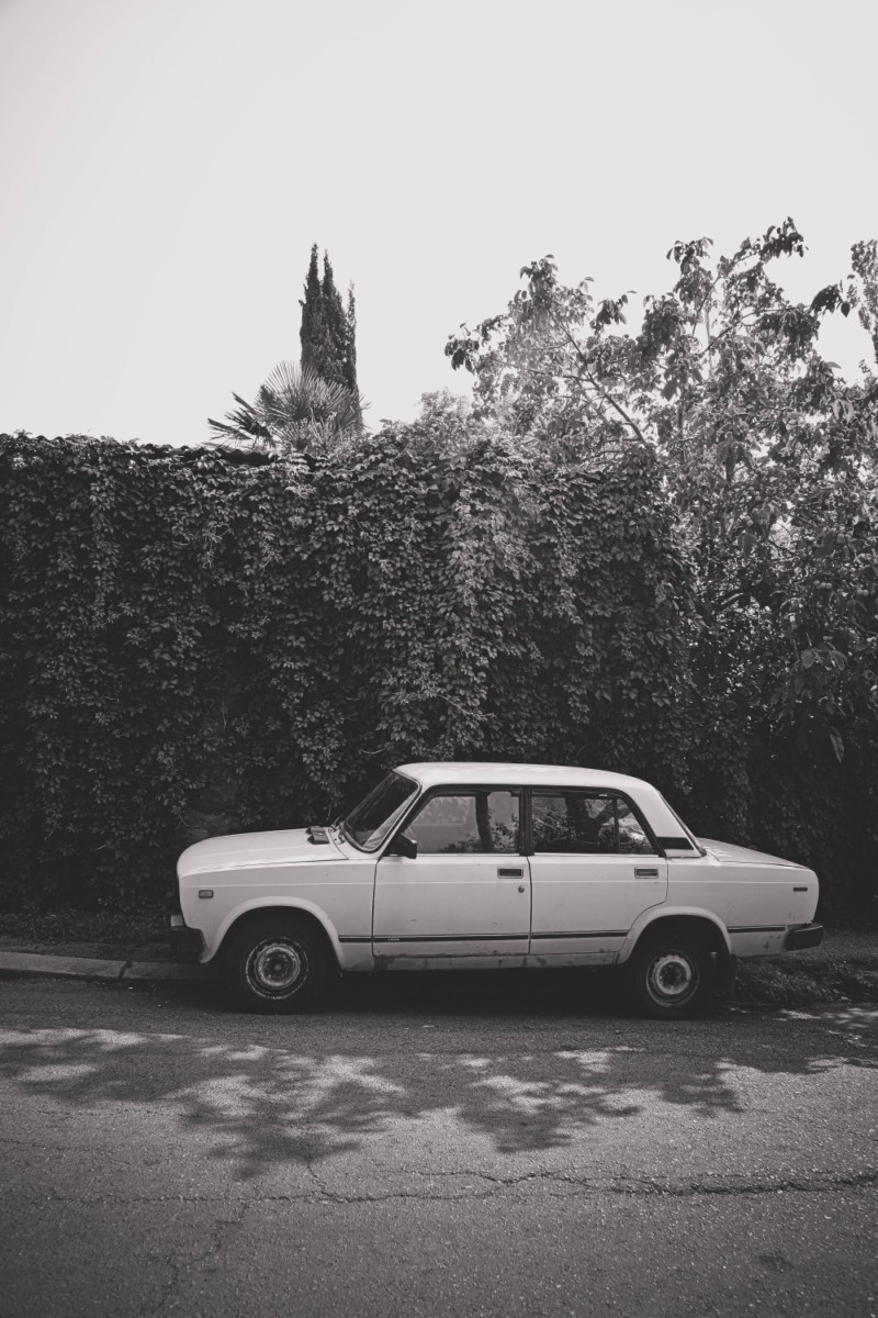 Black and White Photography of a Lada Parked on the Streets