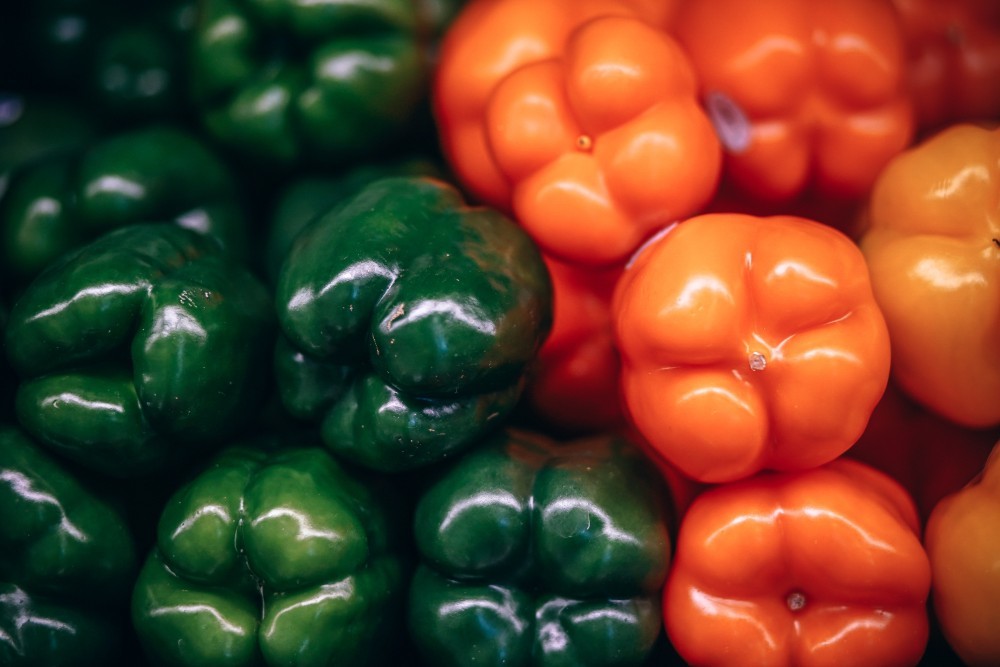 Close up Shot of Organic Green and Orange Bell Peppers
