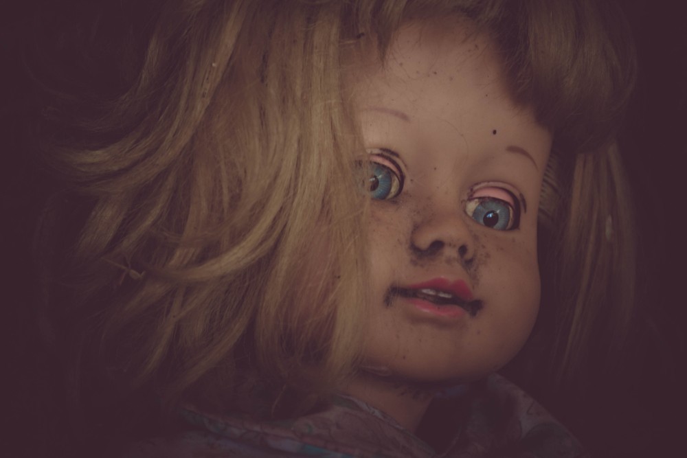 Close-up Shot of a Creepy Vintage Doll in Low Light