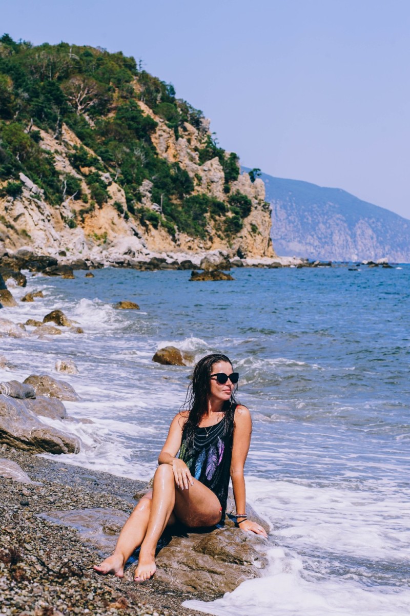 Girl with Sunglasses Posing for a Photograph at the Beach