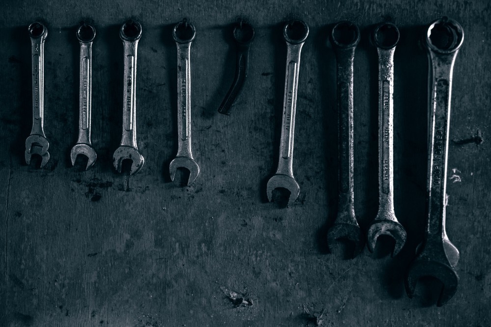 Metal Wrenches Hanging on the Wall in Low Light