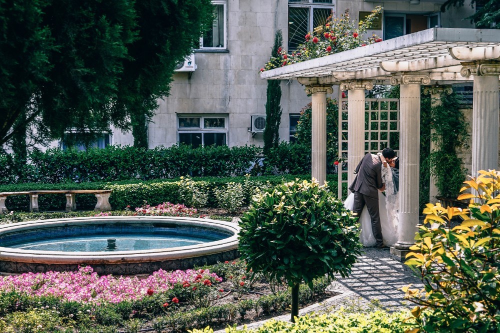 Newly Married Couple Kissing in a Garden