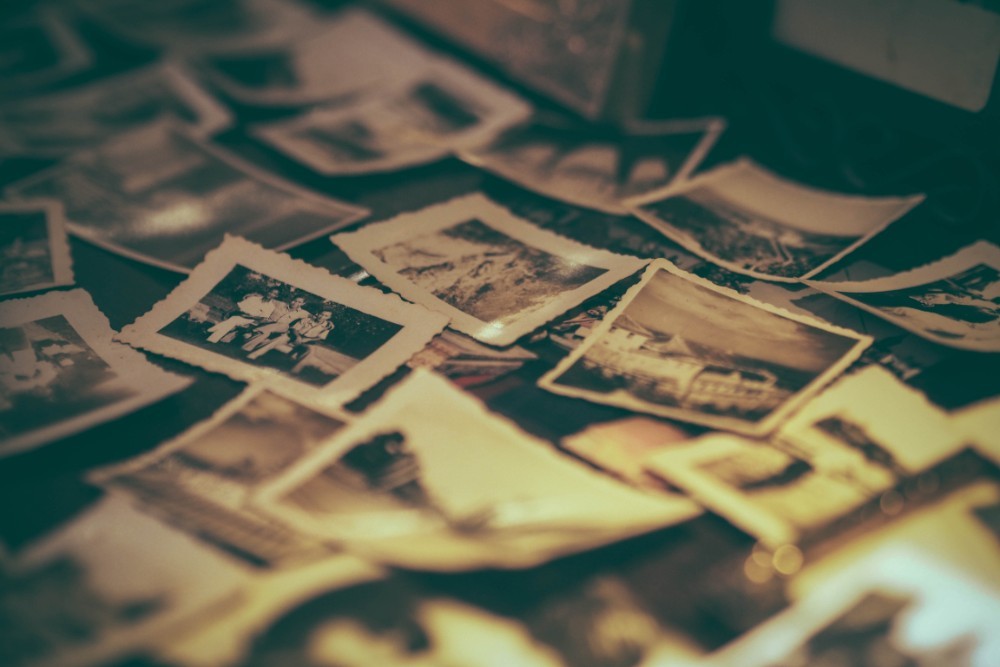 Old Family Photos in Black and White Stacked on a Table