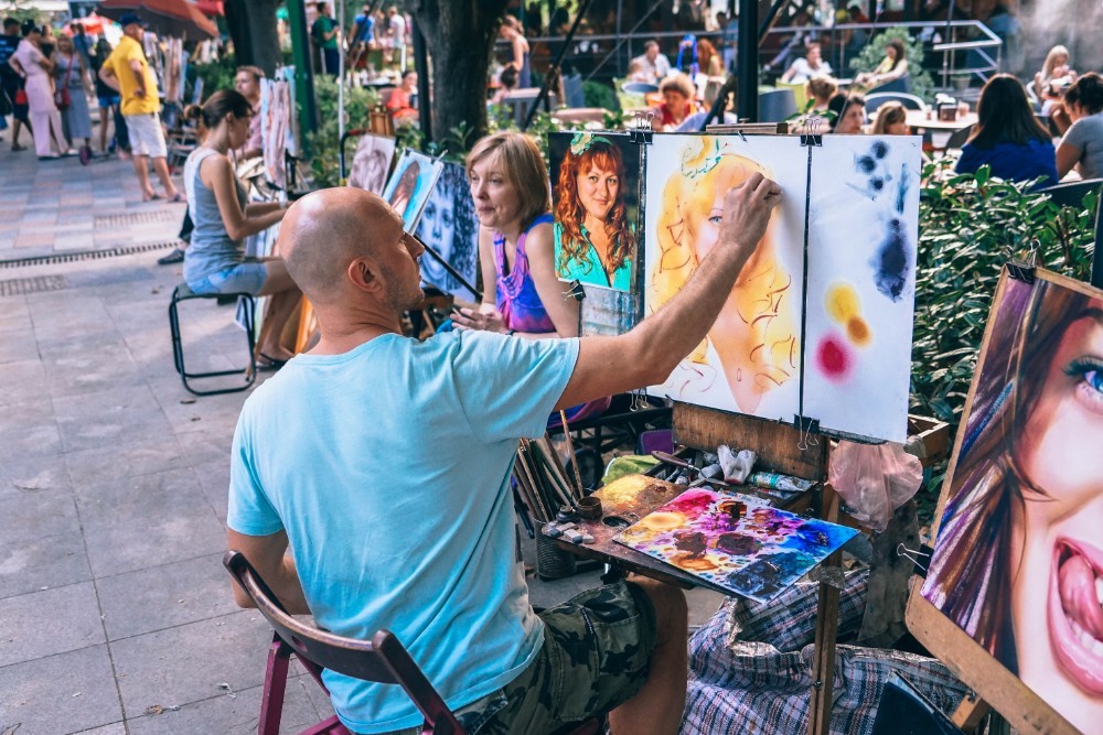 Street Artist Working on a Woman’s Portrait