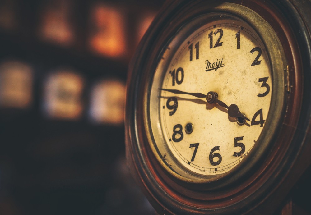 Vintage Clock with a Wooden Frame and Metal Hands