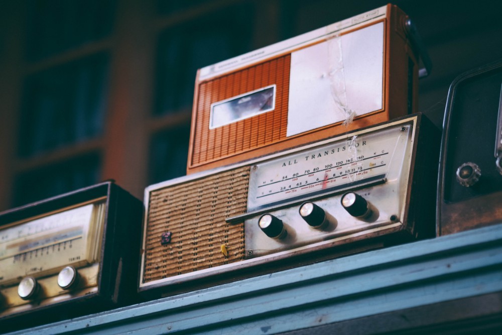 Vintage Radios Placed on a Blue Shelf