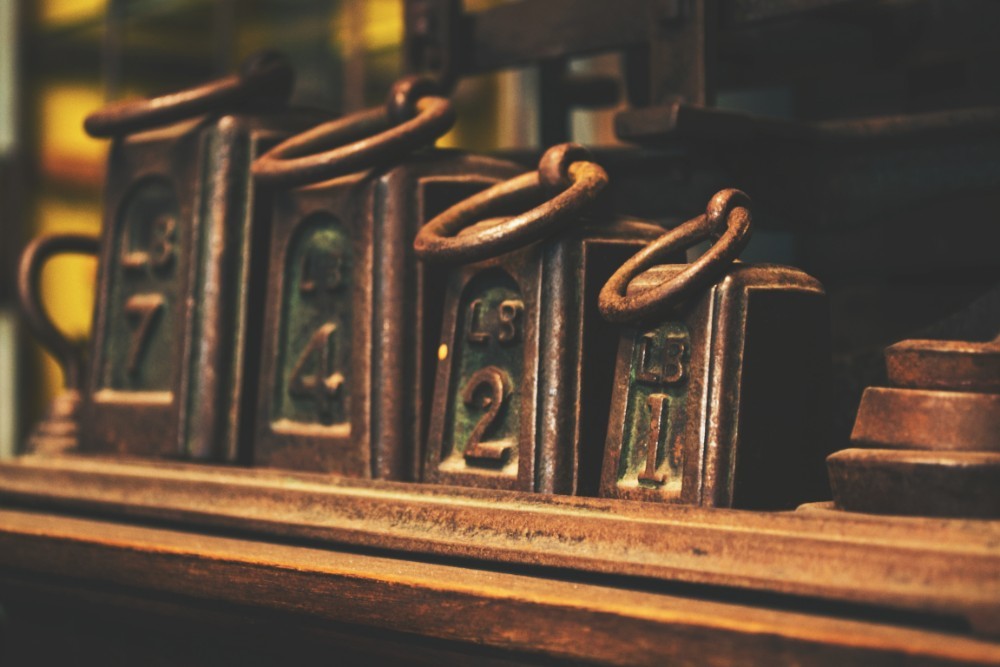 Vintage Weights on a Shelf Ordered by Weight