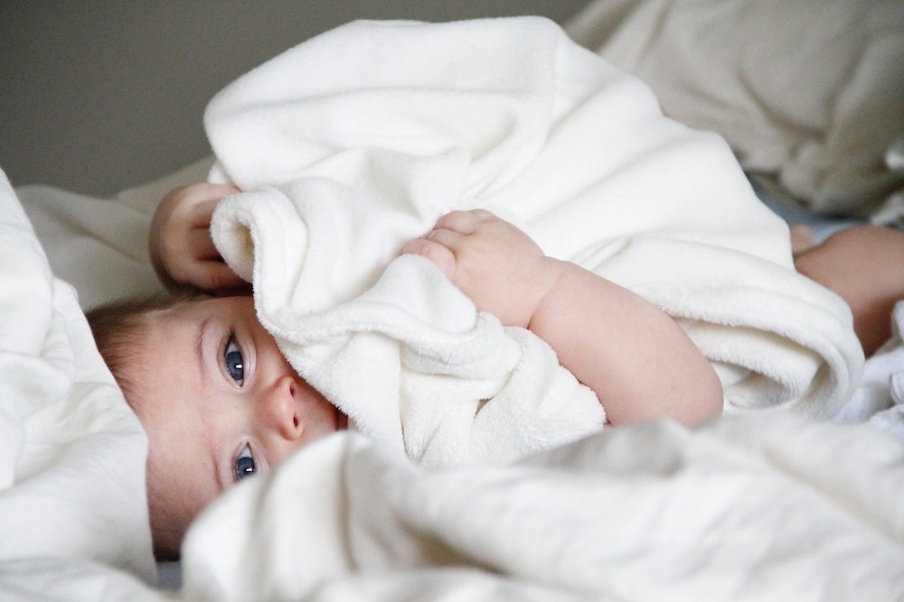 baby lying on bed