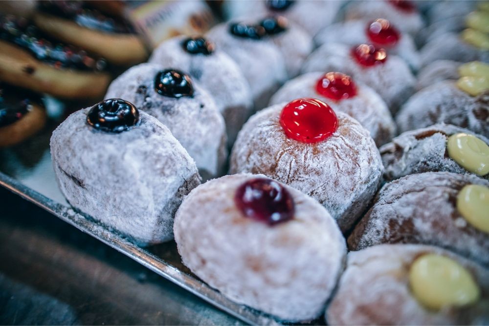Close up Shot of Powdered Sugar Donuts with Jelly on Top