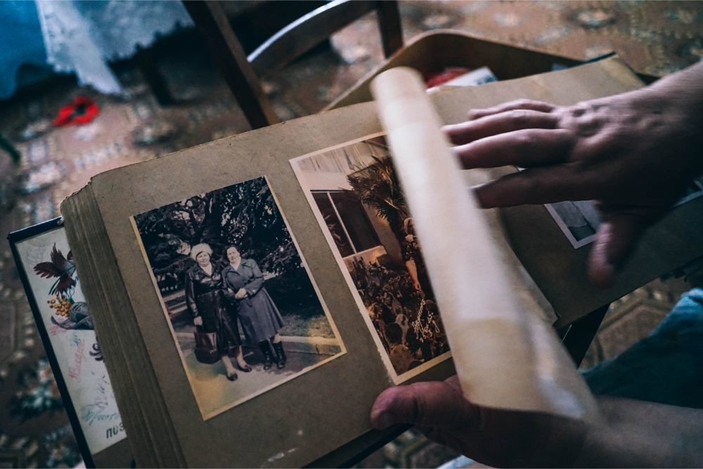 Hands Flipping a Page on an Old Family Album