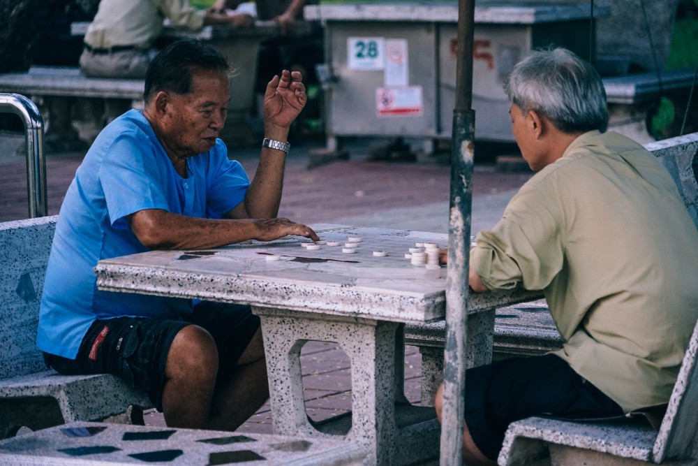 Old Asian Men Playing Checkers