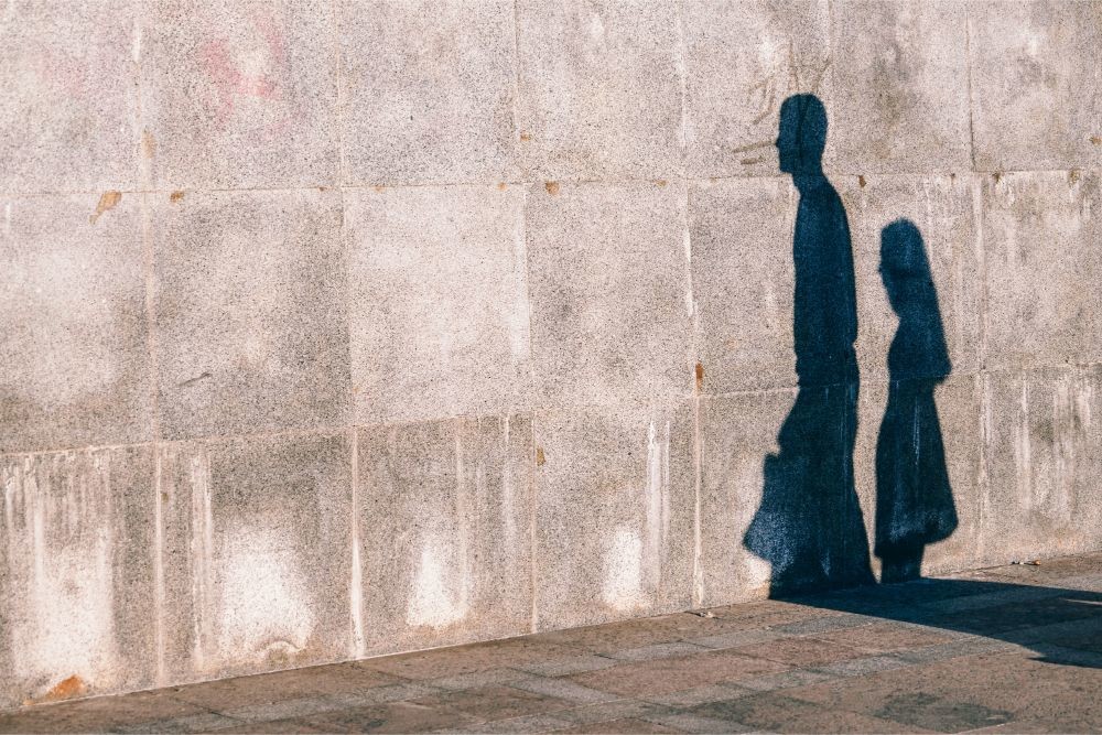 Shadows of a Man and a Woman on a Stone Wall