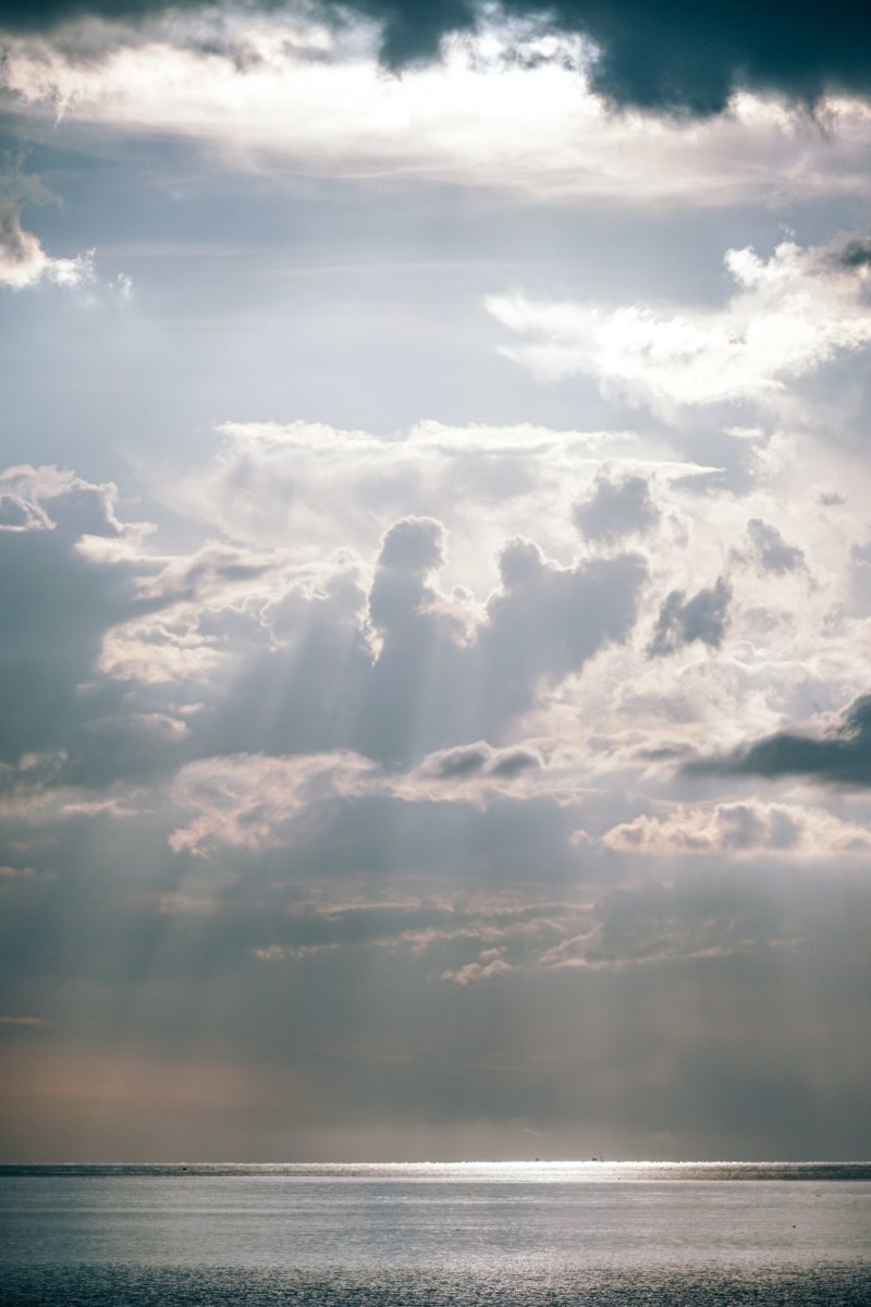 Sun Shining Through Puffy Clouds