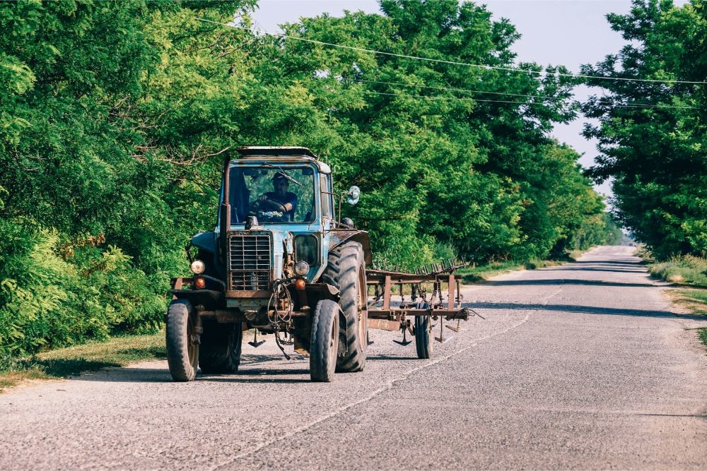 Tractor Driving Through a Russian Country Side Road