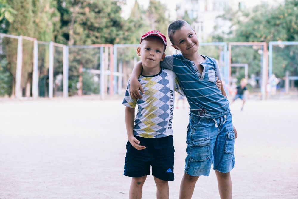 Two Kids Hugging and Posing at a Soccer Field in Sevastopol