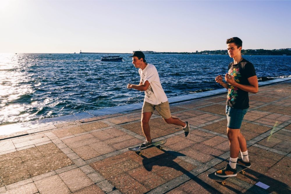 Two Young Men Skating on the Promenade in Sevastopol