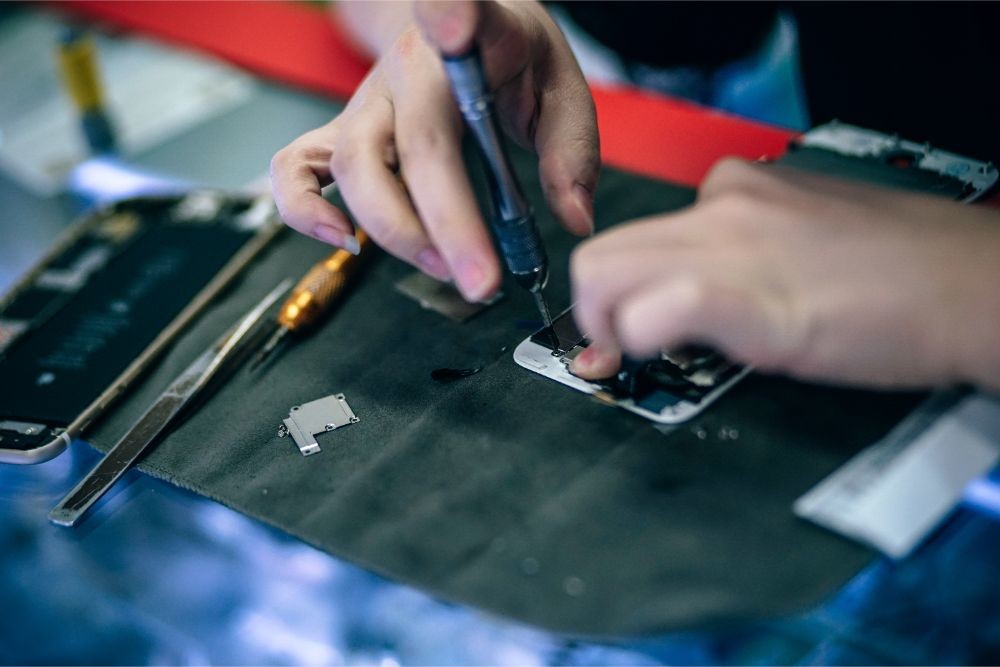 Woman Repairing a Smartphone