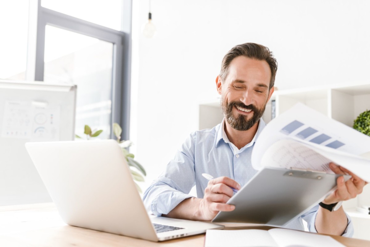 happy businessman holding folder RLAJFDU