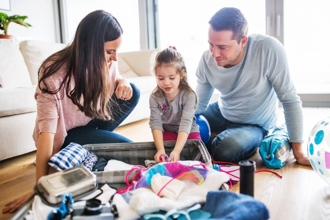 young family with a child packing for holiday PJRQCG