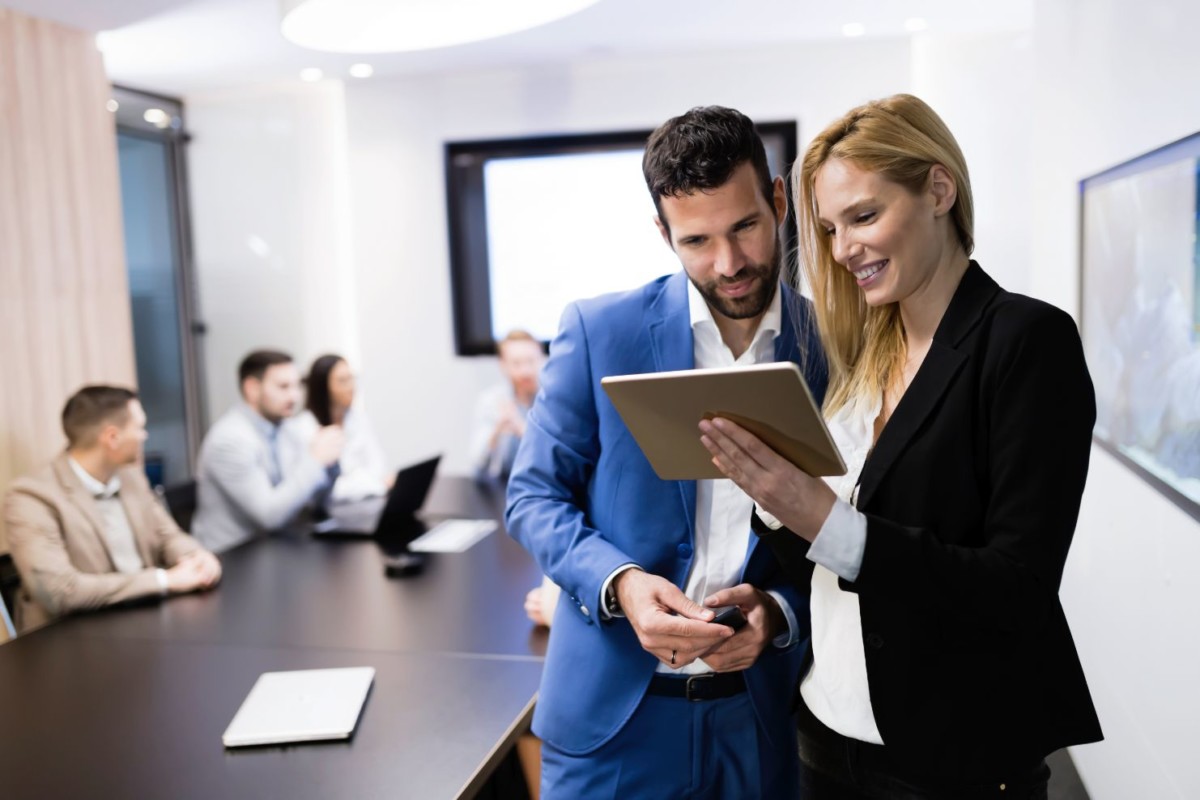 attractive business couple using tablet in their JLLMA