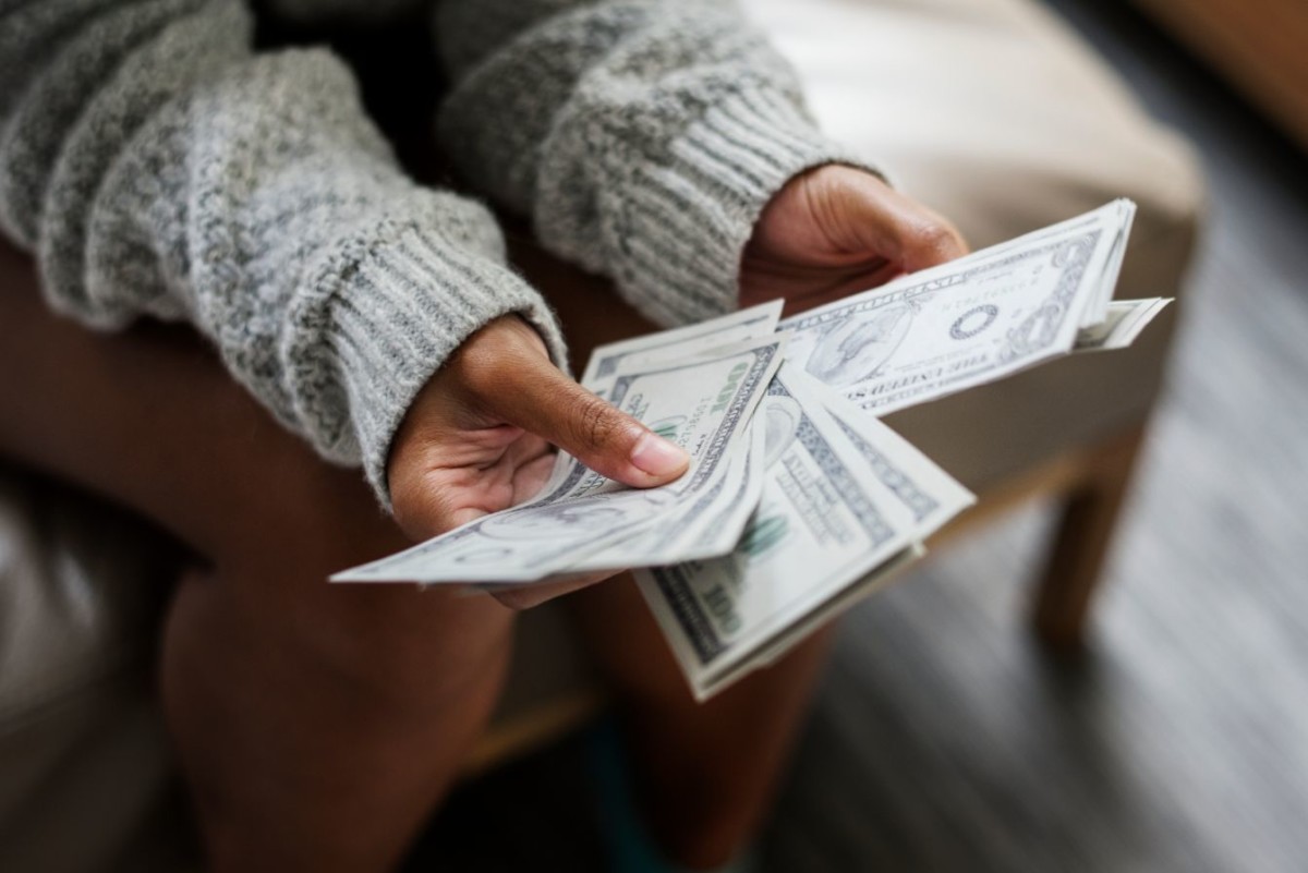 closeup of woman counting money PABQES