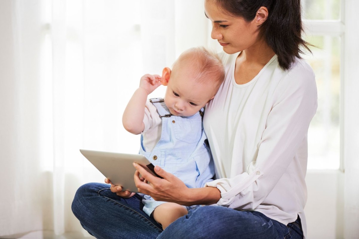 mother showing cartoon to baby FWCR