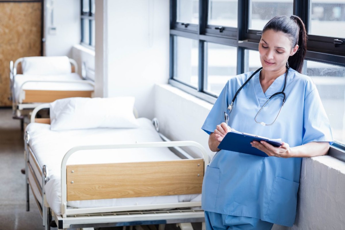 nurse writing on a clipboard in the hospital PZPXL