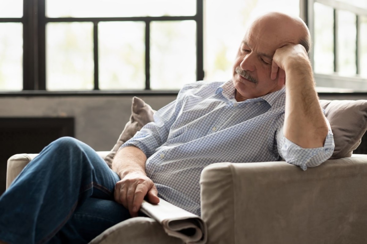 tired senior hispanic man sleeping on couch ECSF