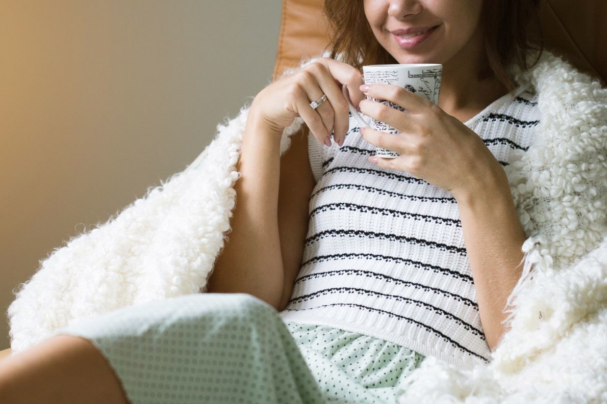 young beautiful girl with a cup of coffee sitting PWJHK