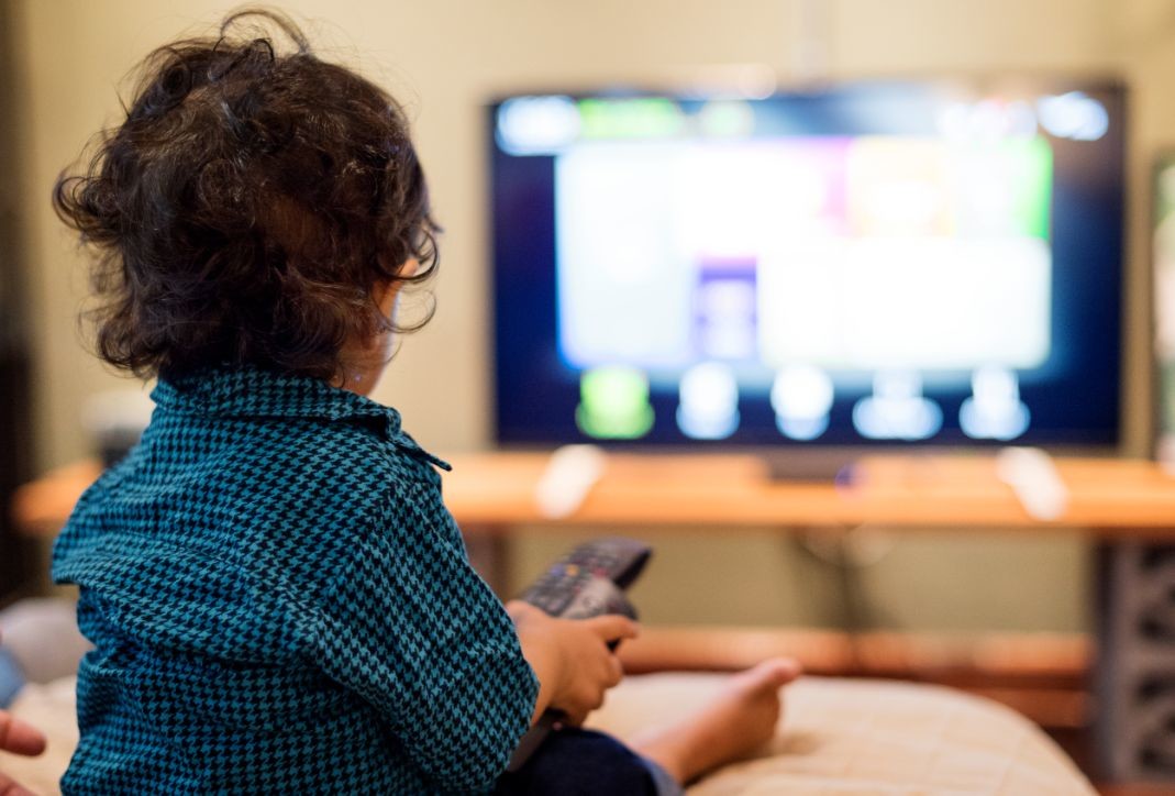 young indian boy watching television PCFTJE